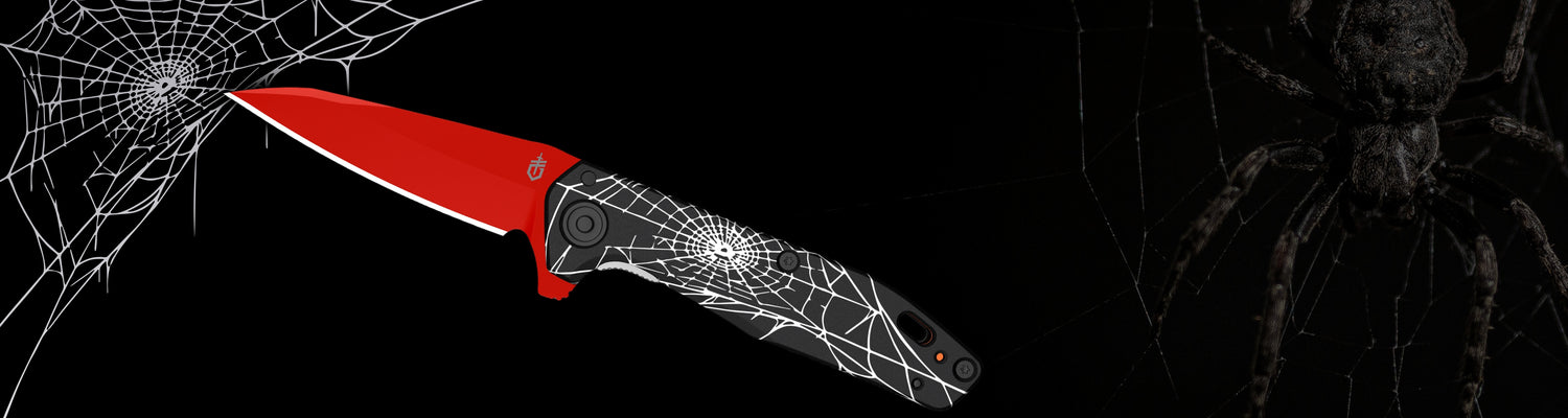 Red knife with spider web design on a black background