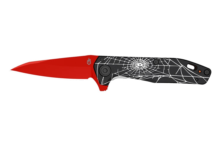 Folding knife with red blade and black handle featuring a spider web design on a white background